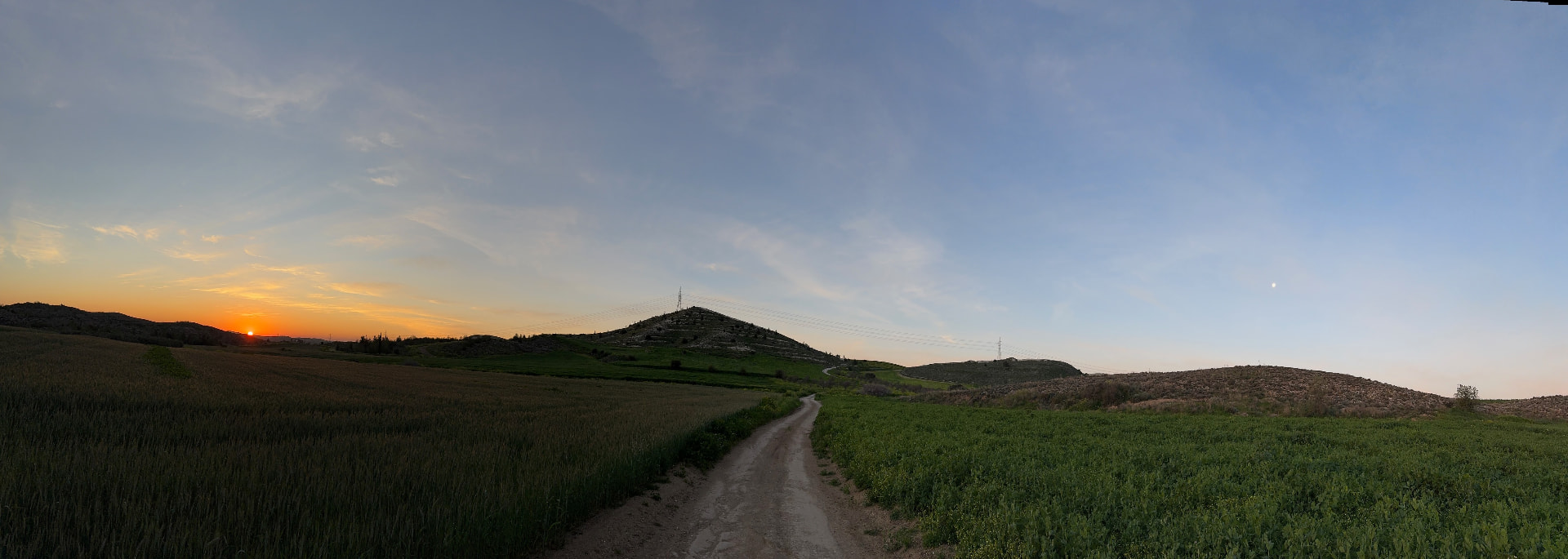 Panoramic sunset over the dirt track from Avdellero toward Koshi village