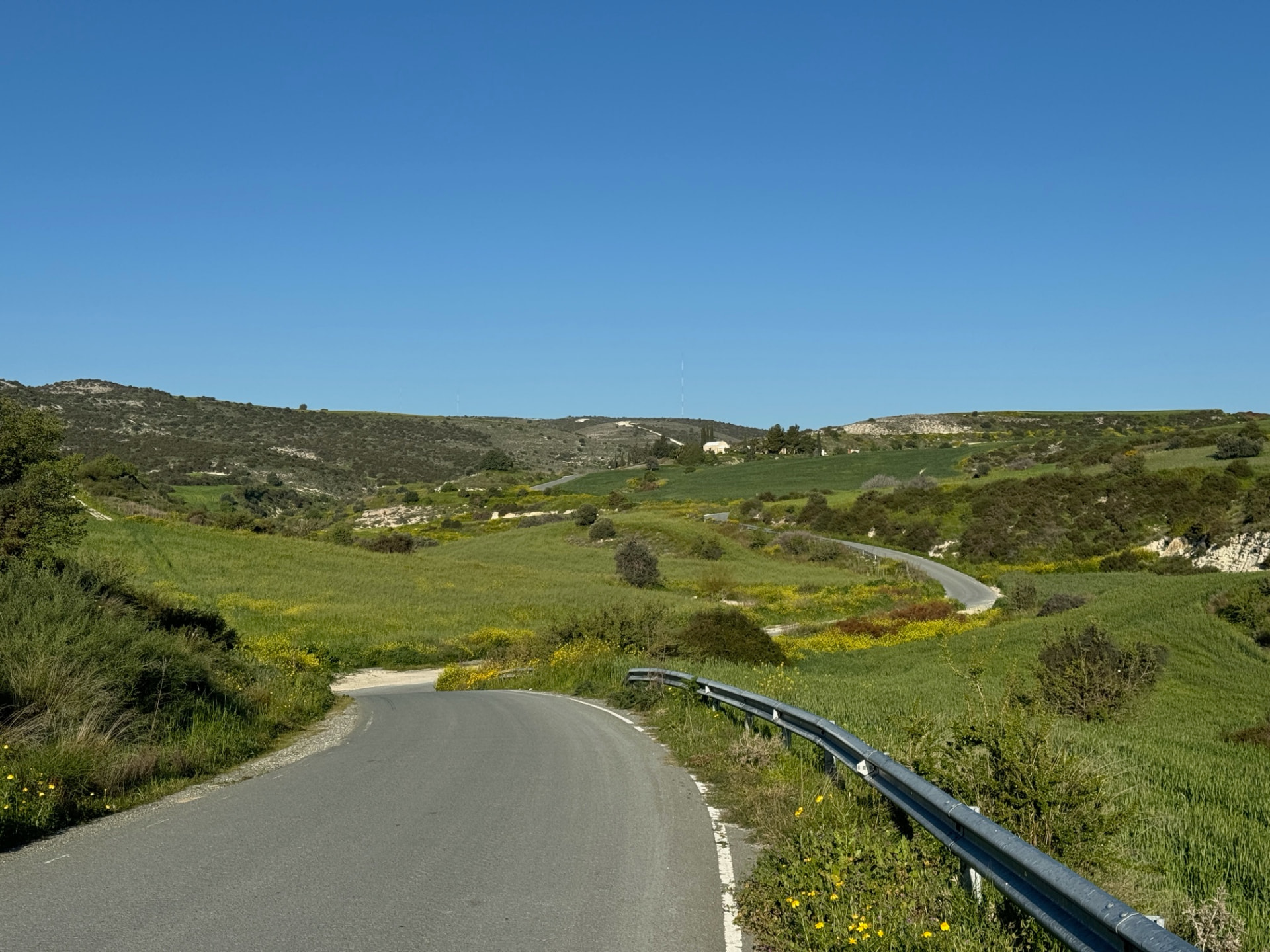 Winding road through the green valley between Klavdia and Pyrga village