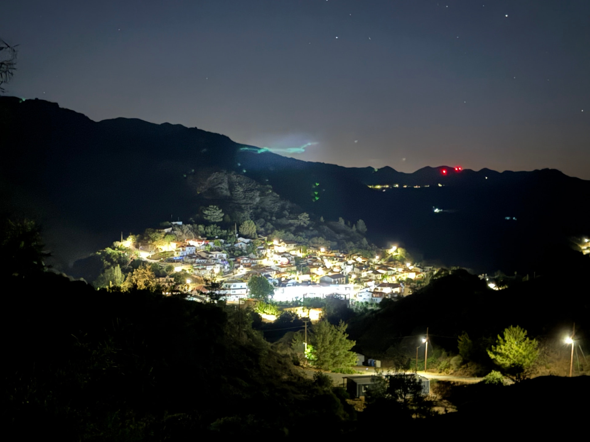 A village lit up in the mountain valley