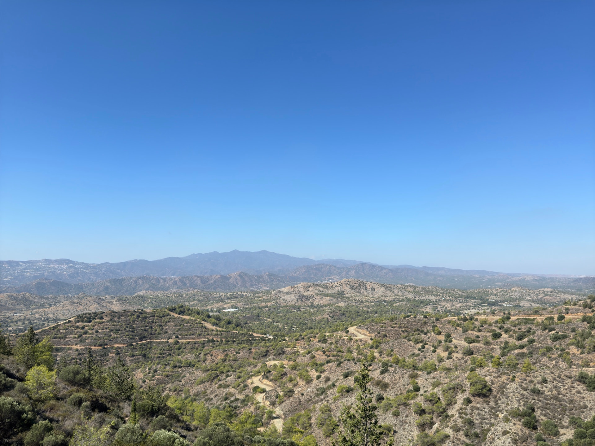 A wide view over hills toward the distant Troodos mountains