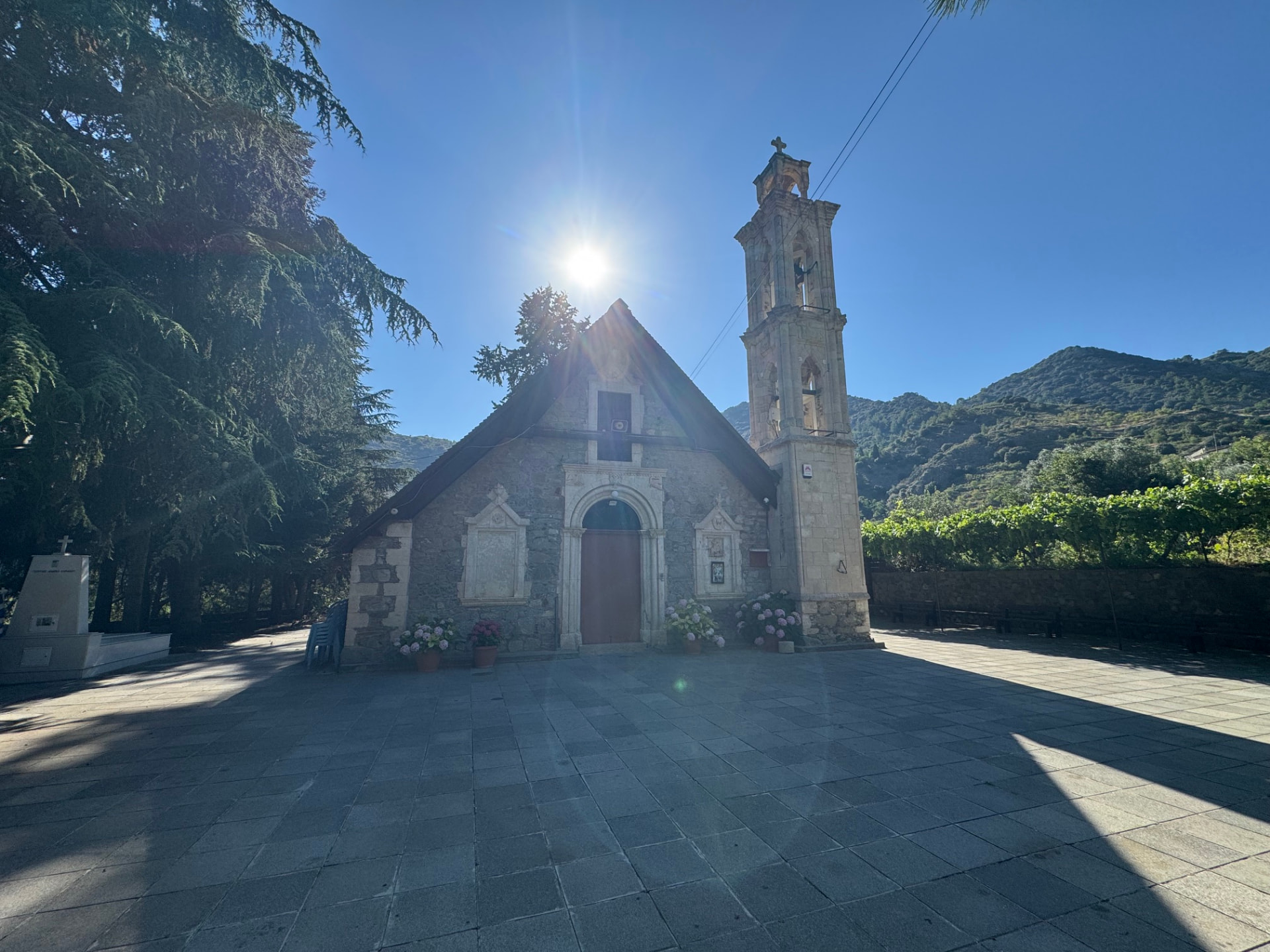 A stone church and bell tower in the sunshine