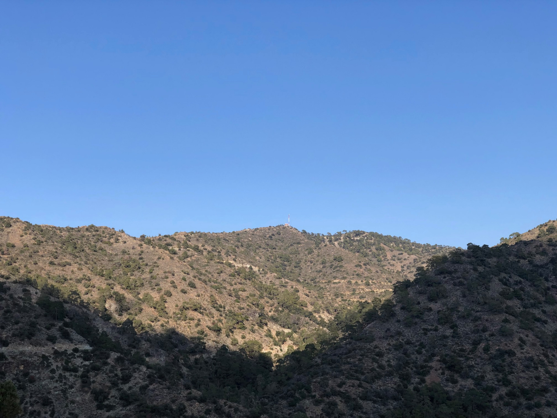 Bare hills leading up to the Kakomalis ridge in strong afternoon light