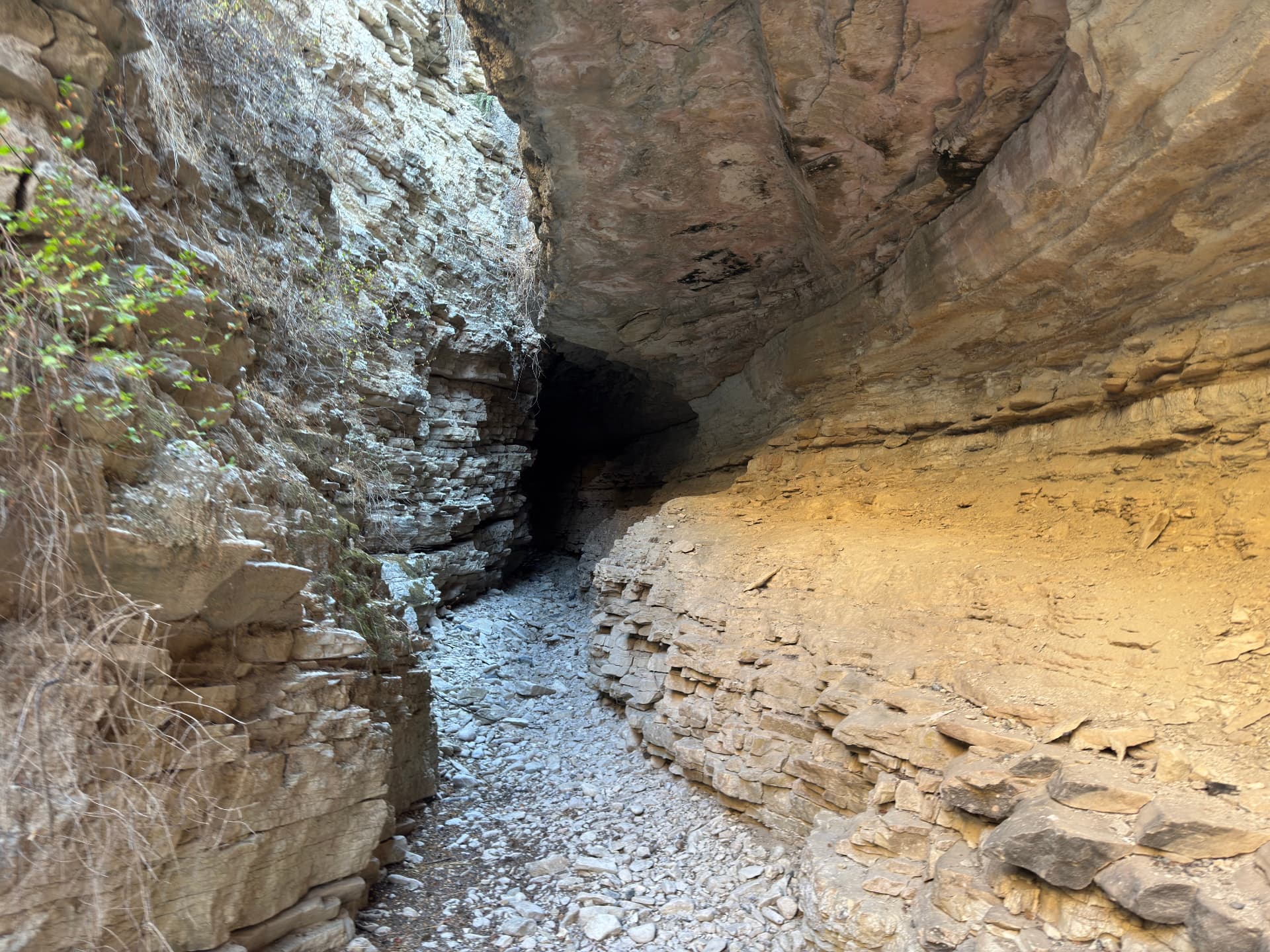 A dark overhang deep in the gorge, the passage narrowing into shadow
