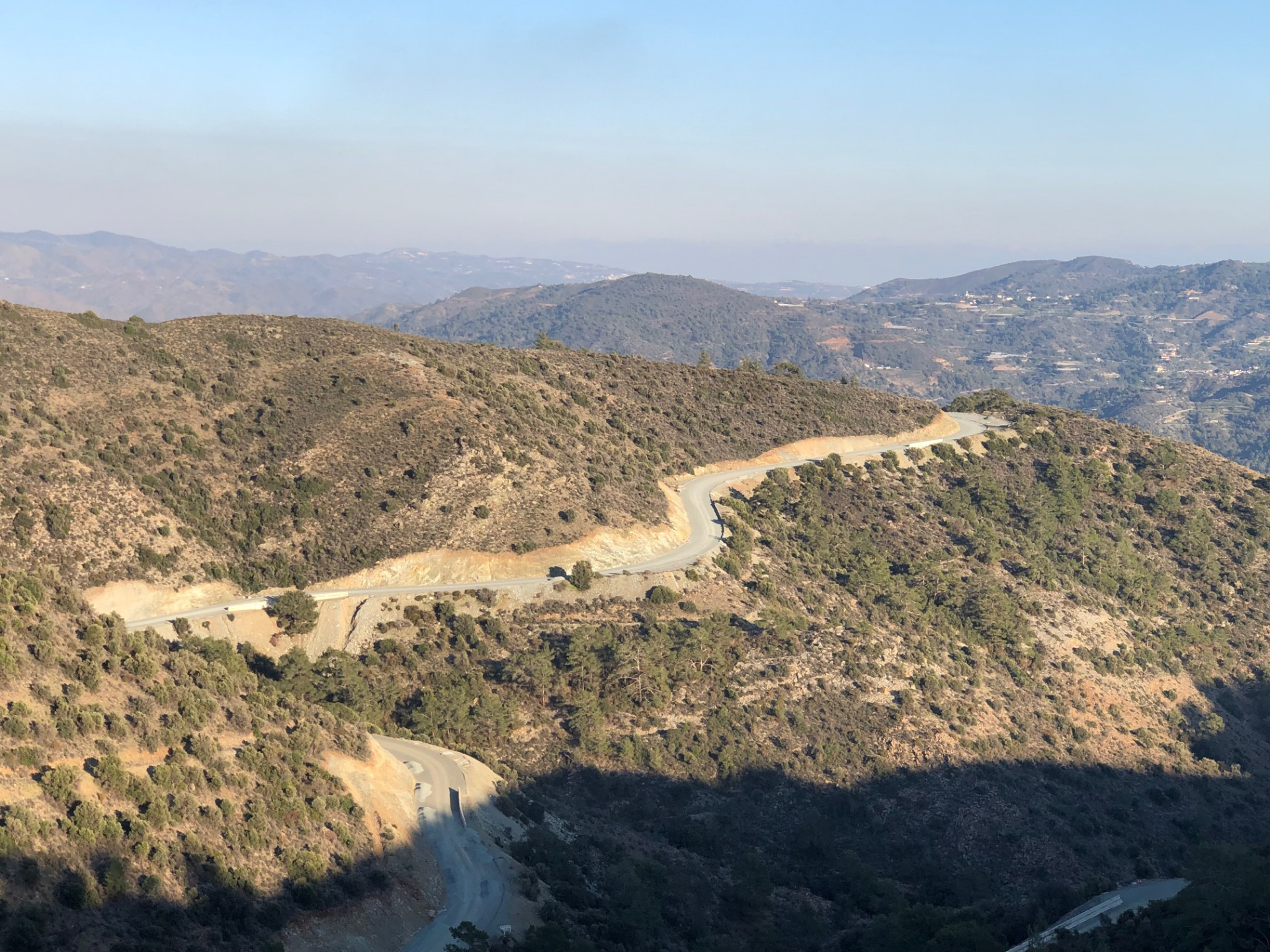 Winding unfinished F128 road cutting through the hills toward Dierona