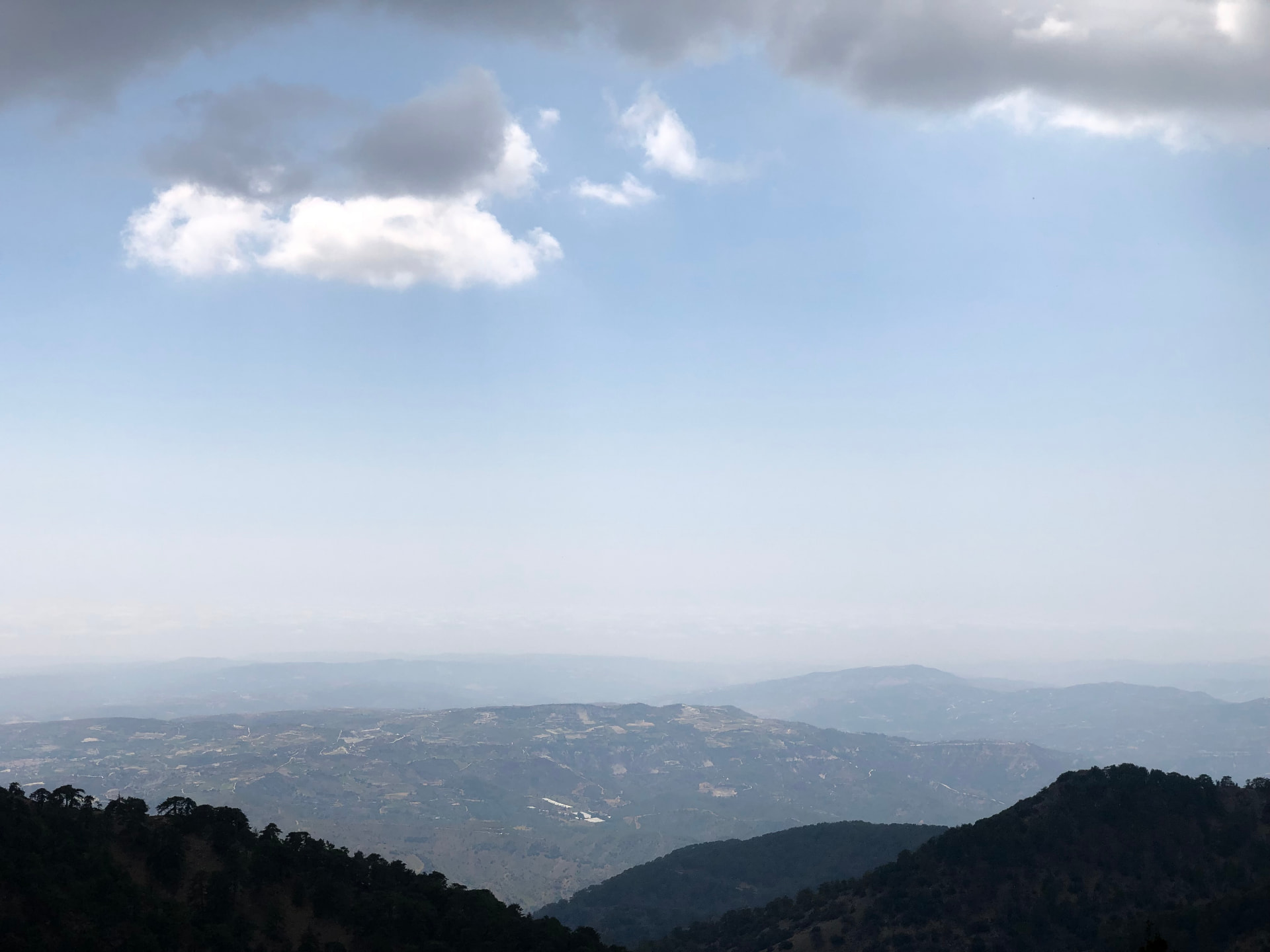 Hazy mountain panorama beneath clouds on the Artemis Trail