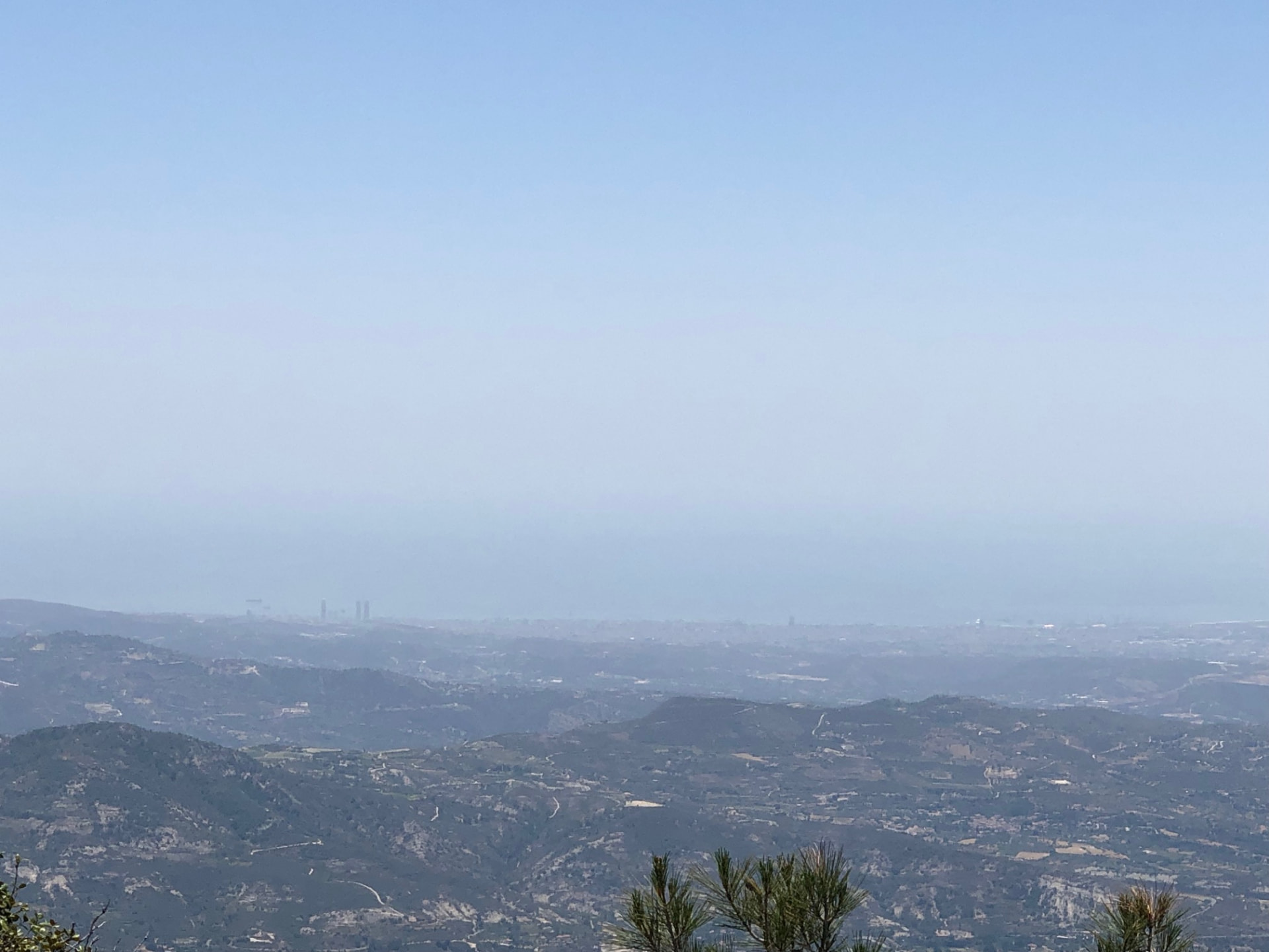 Layers of mountains fading toward the coast in summer haze