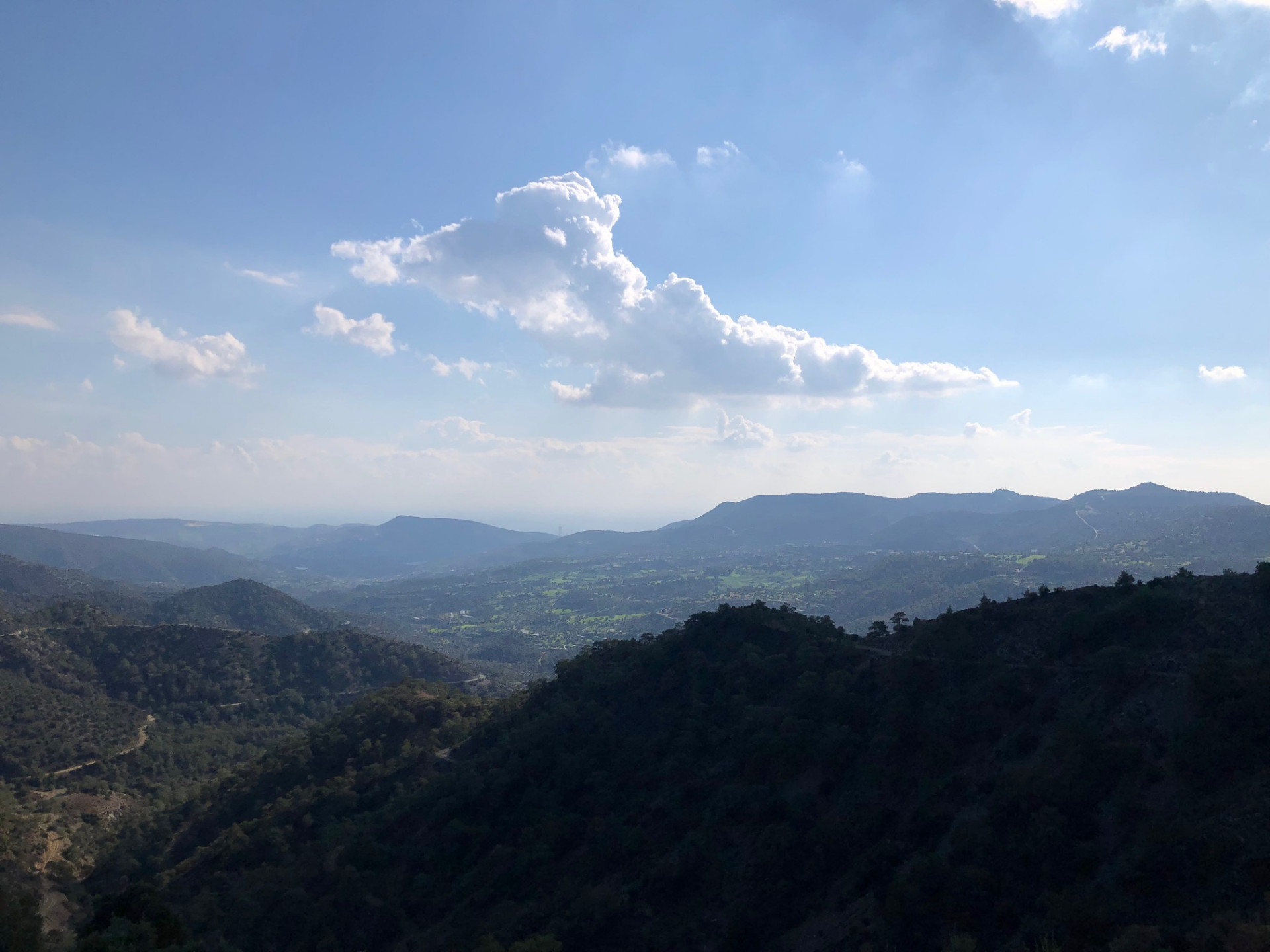 Wide valley view with a single cloud floating above the Troodos foothills